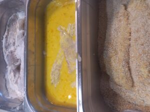 Three stages of crumbing flounder