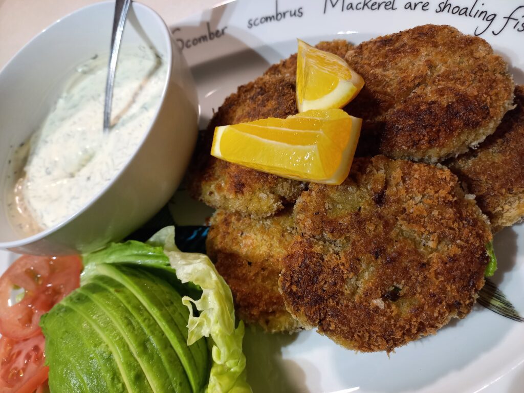 clam fritters, ranch dip, tomato, avocado and lettuce on the side and two lemon edges on top