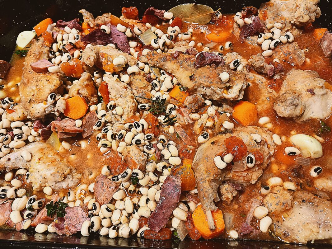 All the ingredients for wild rabbit cassoulet in a baking tray ready to go in the oven
