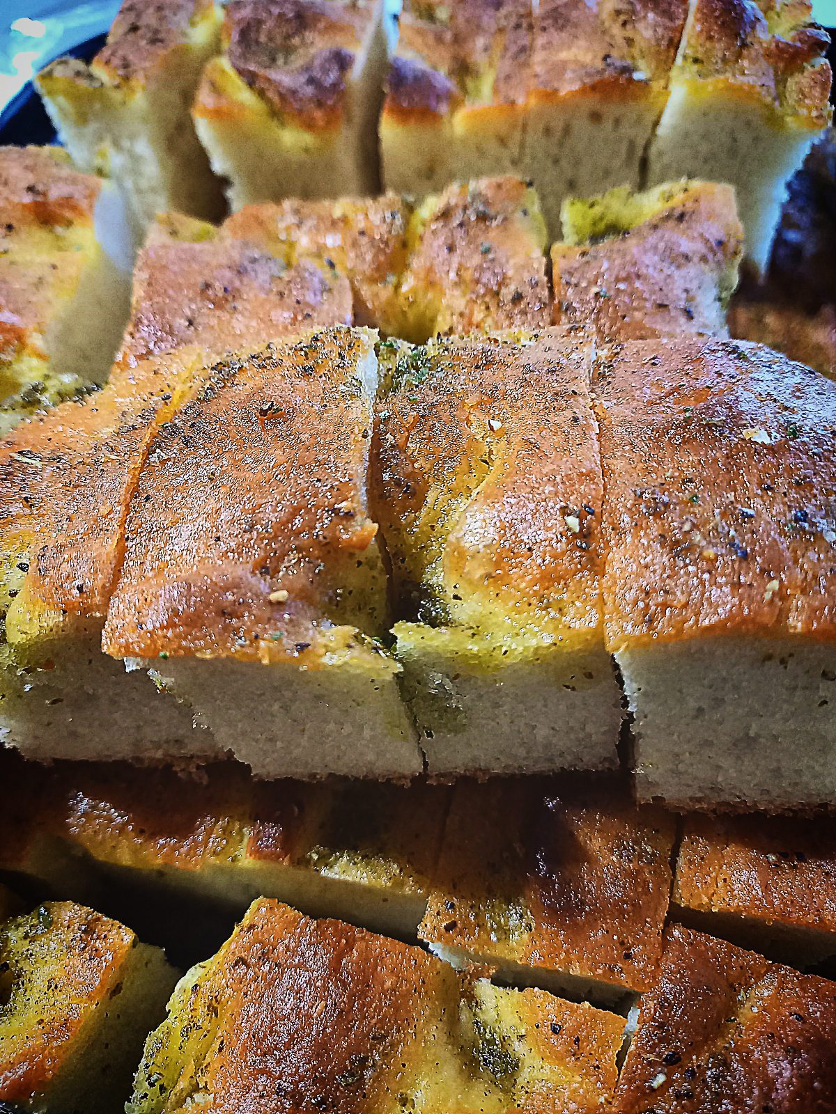 Focaccia bread sliced in to pieces. Stacked on top of each other