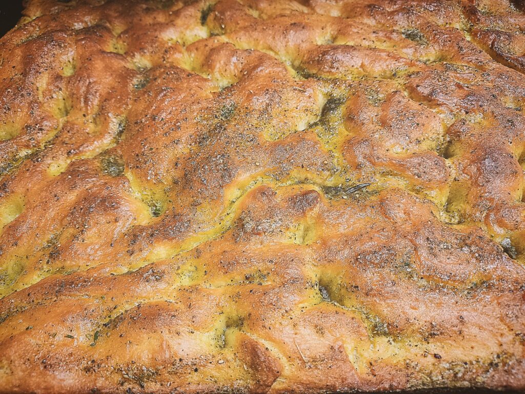 Close up of a whole golden brown Focaccia bread