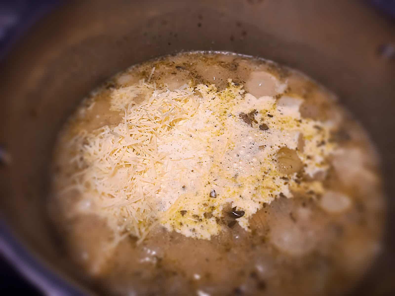 Potato, garlic soup base in a large pot with cream added