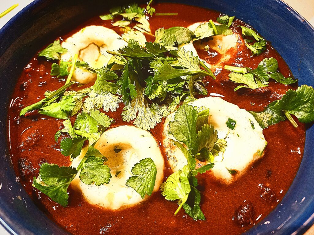 Venison, black bean chilli topped with 4 mexican dumplings and chopped coriander