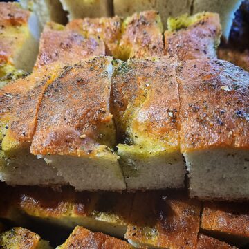 Focaccia bread sliced in to pieces. Stacked on top of each other