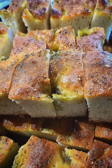 Focaccia bread sliced in to pieces. Stacked on top of each other