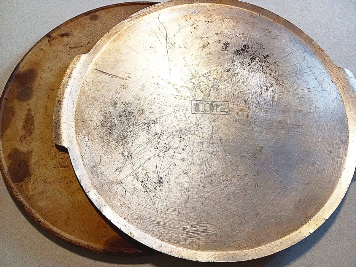 aluminum pizza tray on top of a pizza stone