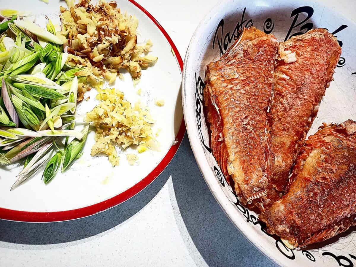 3 Pan fried scarlette wrasse on a plate and the ingredients for the xo sauce on a different plate