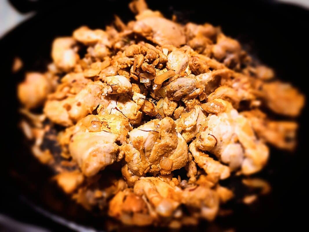 Rabbit pieces frying in a skillet frying pan