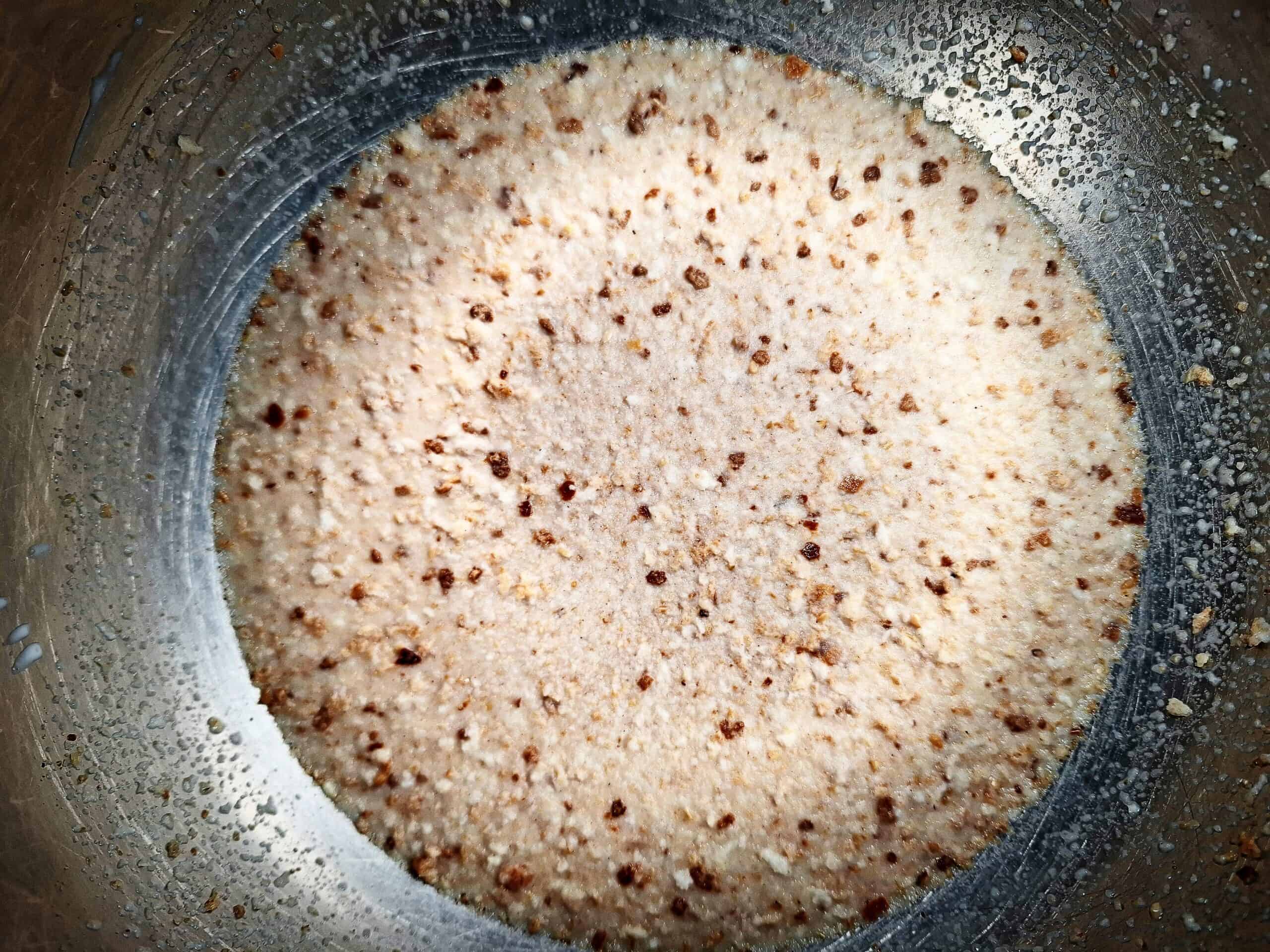 Breadcrumbs soaked in milk in a stainless steel bowl