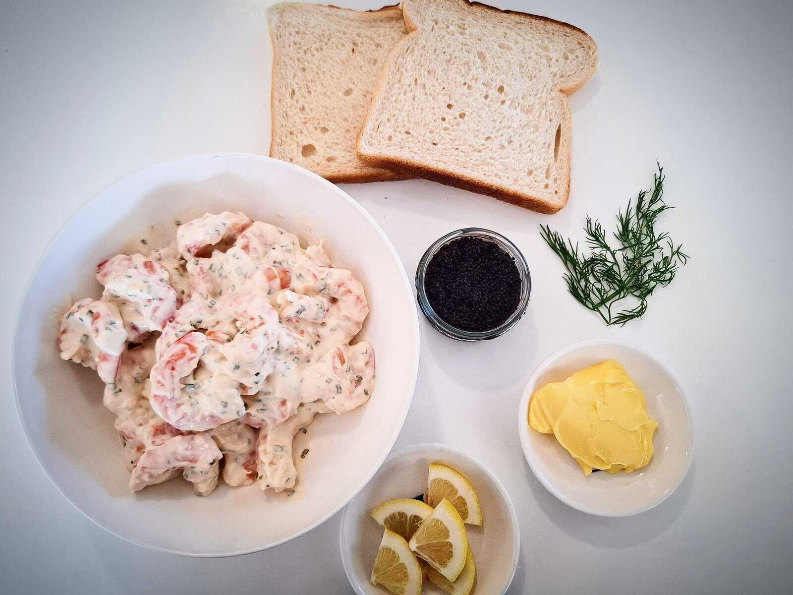 Ingredients for toast skagen on a white table top.