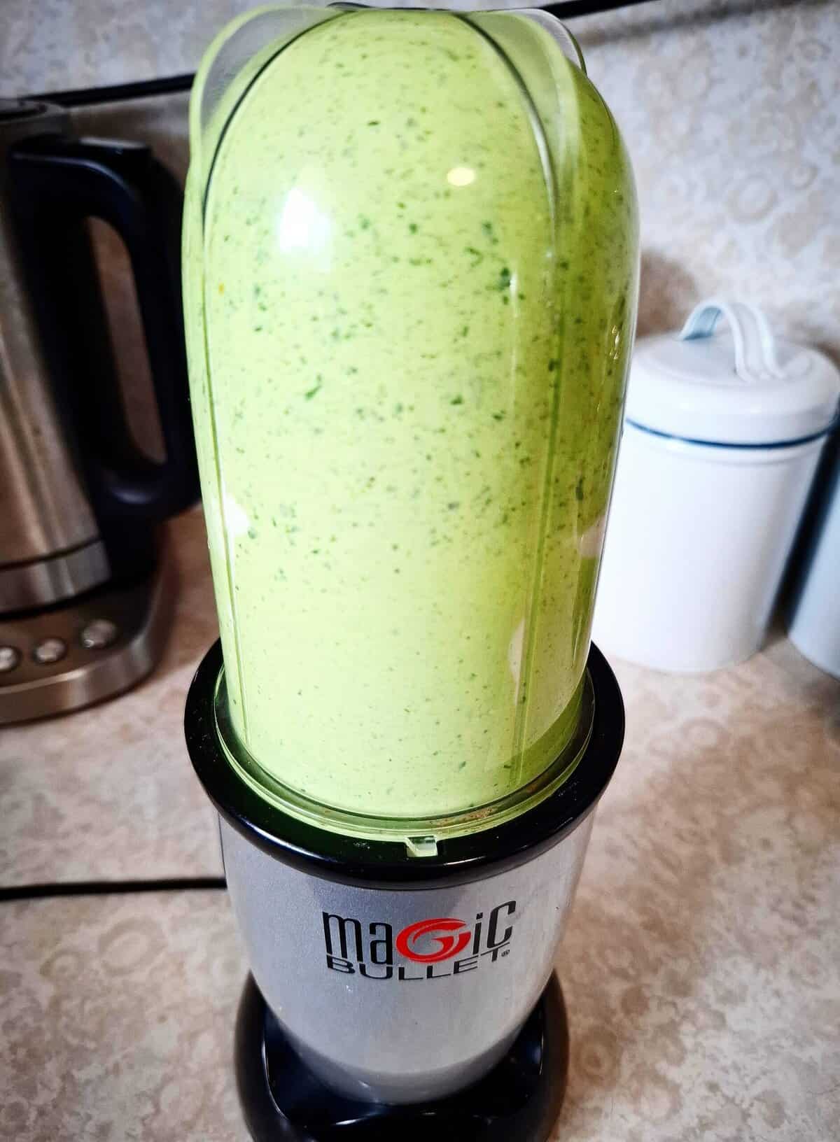 Basil dip being blended in a nutri bullet until smooth