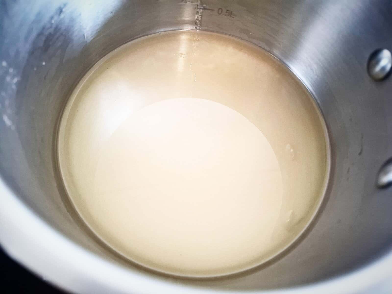 Salt, sugar and rice vinegar simmer in a sauce pan on the stove top
