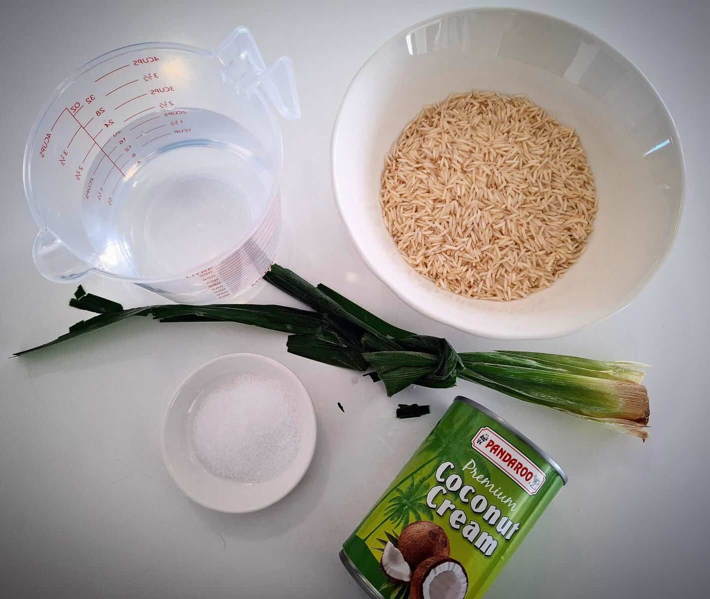 All the ingredients for coconut rice is presented on a white table