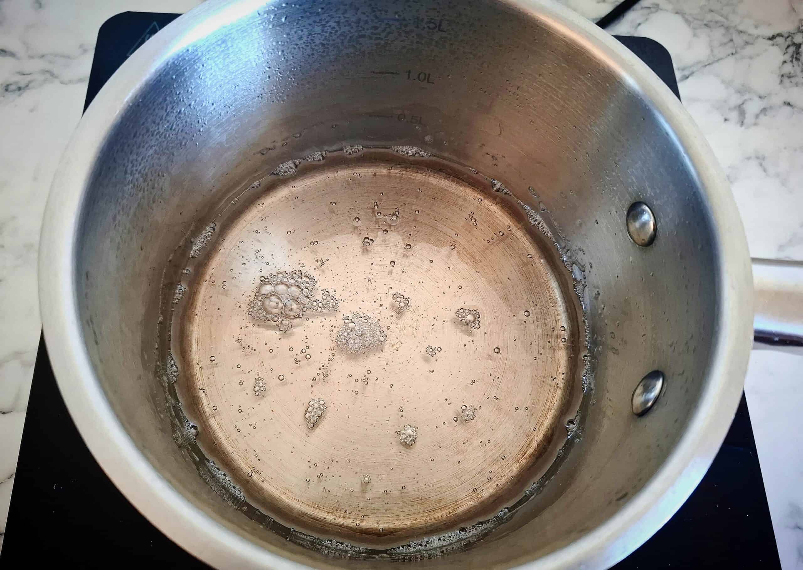 Sugar, rice vinegar and water has been reduced to a sugar syrup in a saucepan