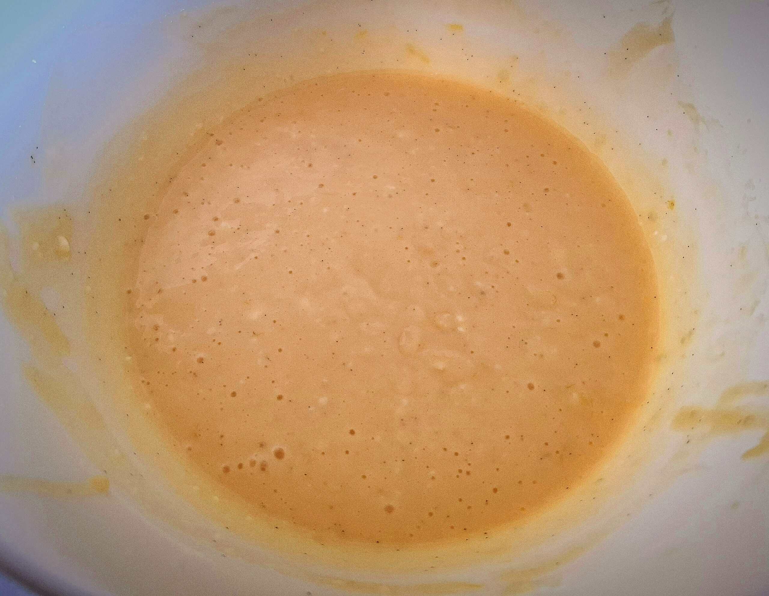 Egg yolks, sugar, cream cheese and lemon have been whisked to a smooth mixture.